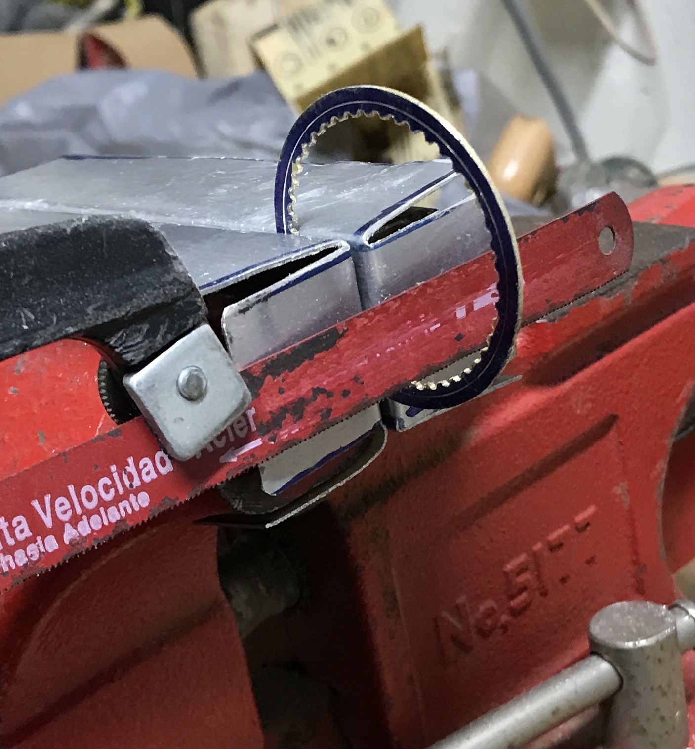 The large gear being cut with the hacksaw